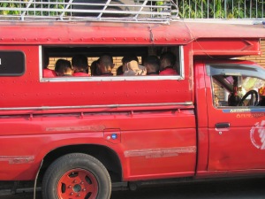 Children going to school in a songtao.